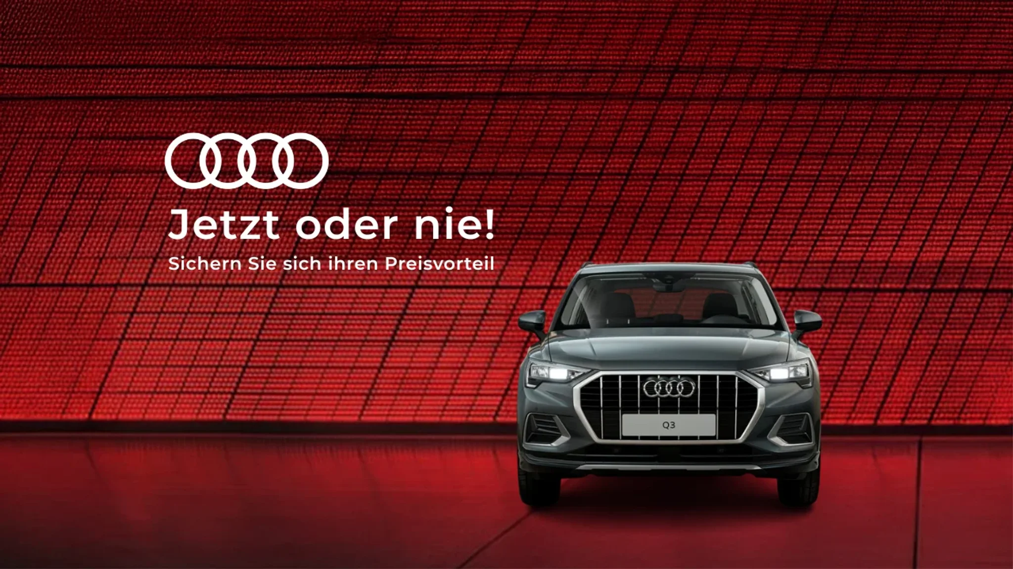 Grauer audi Q3 auf rotem Hintergrund
