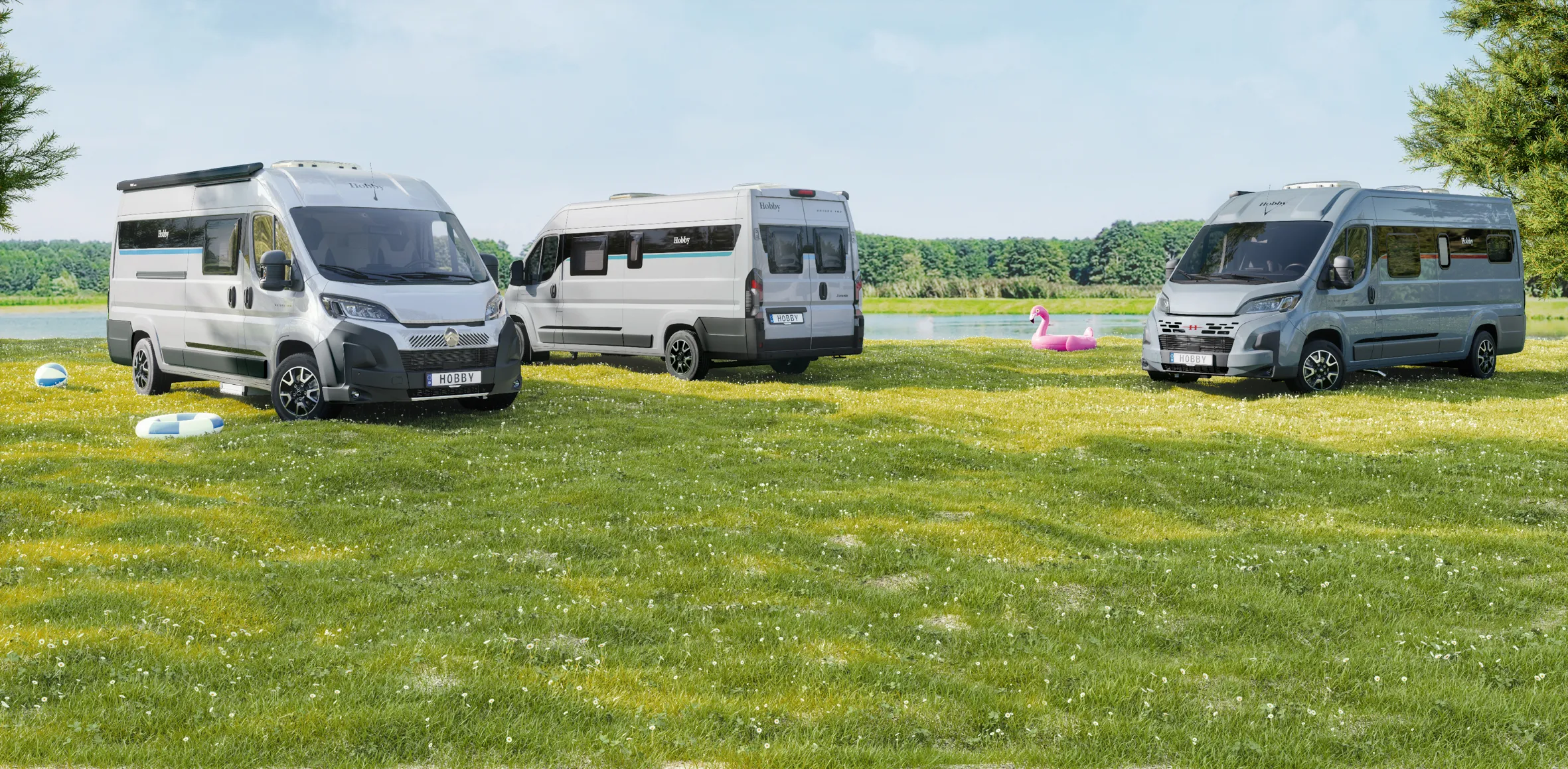 Camper von Hobby auf einer Wiese am See