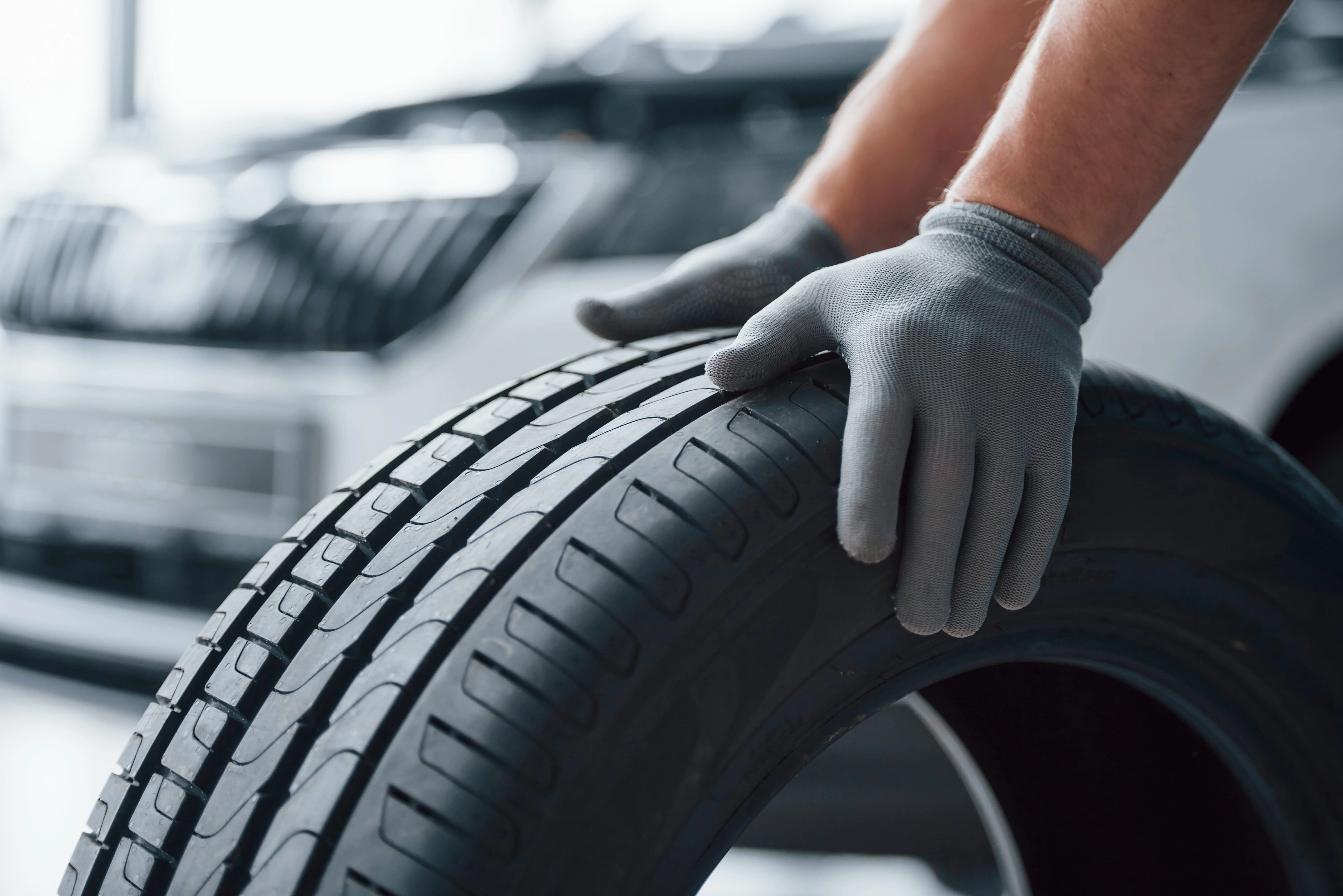 hands-only-mechanic-holding-tire-repair-garage-replacement-winter-summer-tires (1).jpg