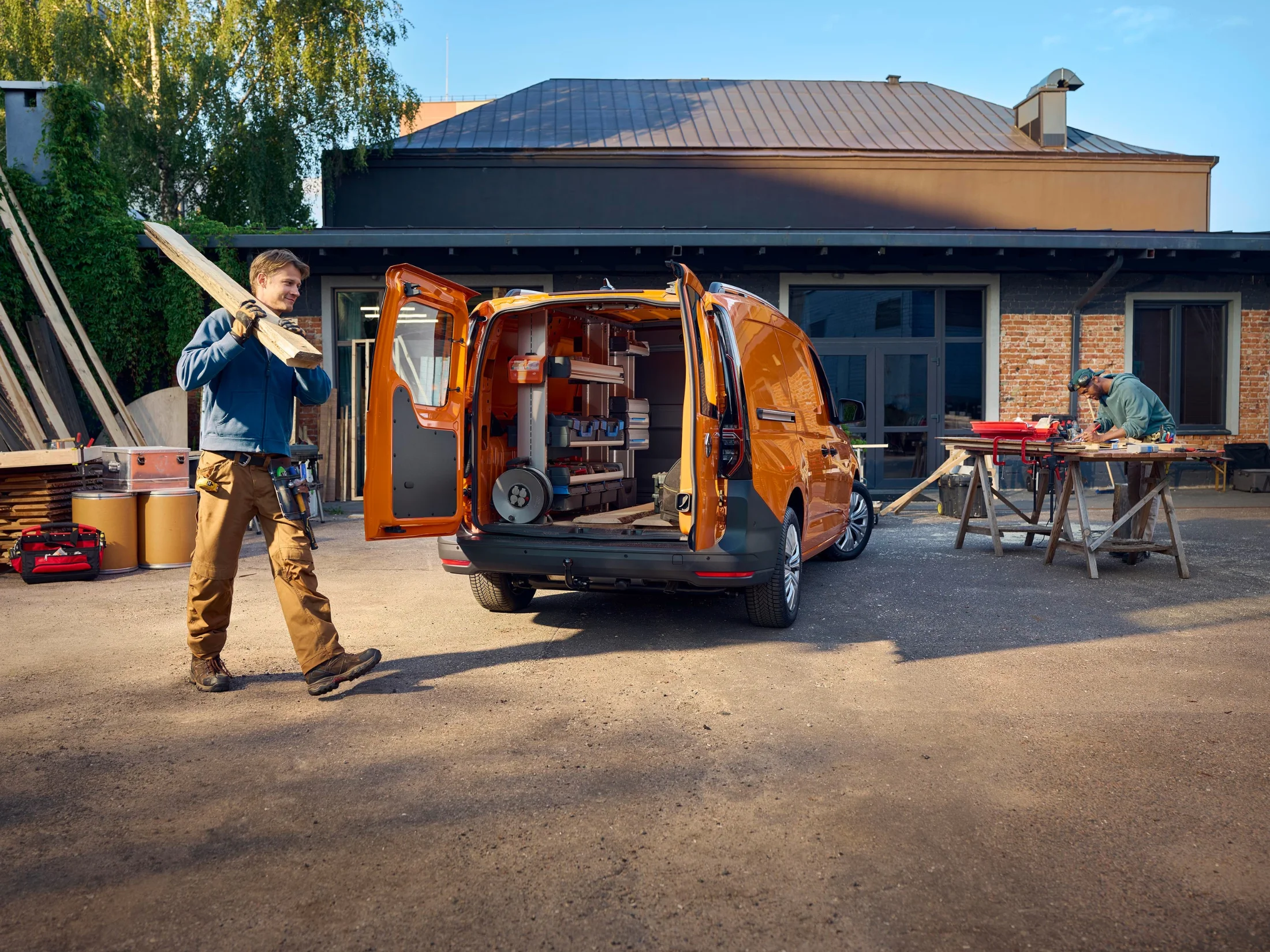 Orangener Caddy Cargo auf einer Baustelle.png